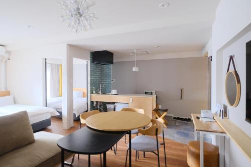 a living room with a table and chairs and a bedroom at Namba Hara apartment in Osaka