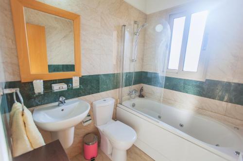 a bathroom with a sink and a toilet and a bath tub at Villa 1 Sandy Beach Villas - Heated pool - Jacuzzi - Private Beach Area - Sea Views in Polis Chrysochous