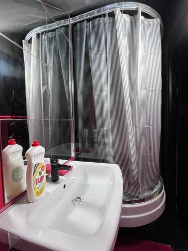 a bathroom with a white sink and a toilet at Stefan cel Mare studio in Chişinău