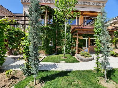 a house with trees in front of it at Pan Asiat in Tashkent