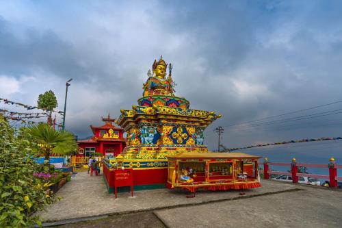 a large colorful structure in front of a building at Zostel Homes Pedong, Kalimpong in Kalimpong