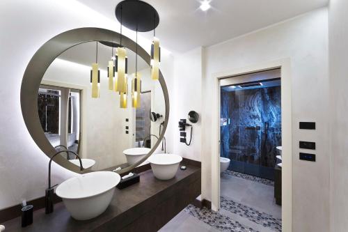 a bathroom with two sinks and a large mirror at Vip's Motel Luxury Accommodation & Spa in Lonato del Garda