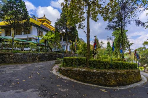 a street in front of a building with a stone wall at Zostel Homes Pedong, Kalimpong in Kalimpong