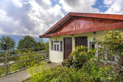 a small house with a red roof at Zostel Homes Pedong, Kalimpong in Kalimpong