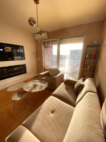 a living room with a couch and a table at Allure Apartments in Ohrid
