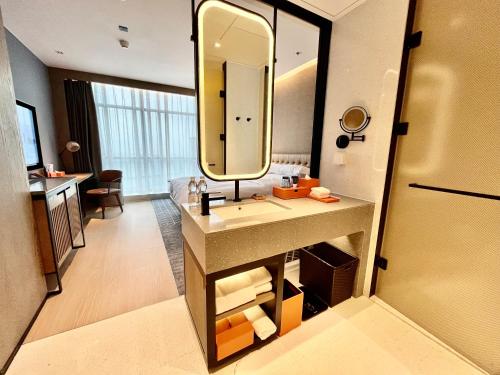 a bathroom with a sink and a mirror at Four Points by Sheraton Chongqing, Yongchuan in Yongchuan