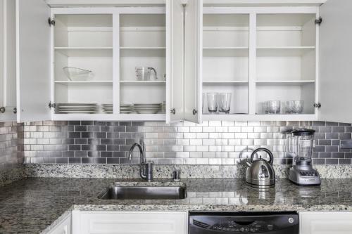 a kitchen with white cabinets and a sink at River N 2BR w Gym WD nr Magnificent Mile CHI-160 in Chicago