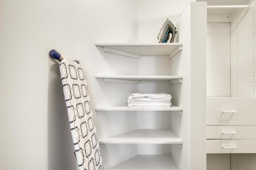 a closet with white shelves and a shower curtain at Streeterville 1BR w Gym Pool nr Navy Pier CHI-411 in Chicago