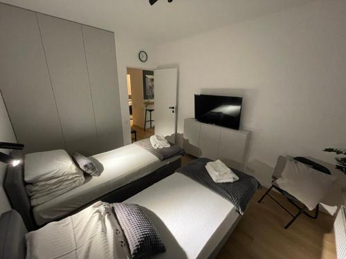 a hotel room with two beds and a tv at APARTAMENT 4 bed 2 room WARSAW in Warsaw