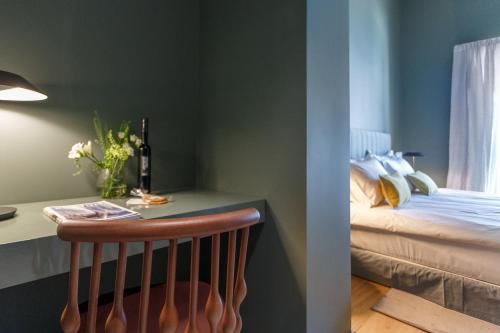 a bedroom with a bed and a table with a chair at Bordoy Casa Ládico - Hotel Boutique Adults Only in Mahón