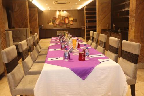 a long table in a room with a purple table cloth at Kyriad Hotel Indore by OTHPL in Indore
