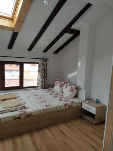 a bedroom with a bed and a window at Guest House Proynovi in Kalofer