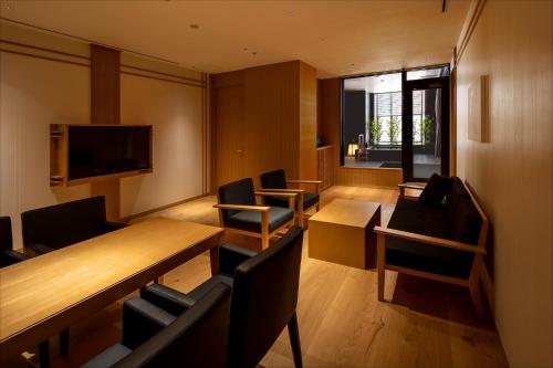 a conference room with a table and chairs and a television at Pearl Star Hotel ATAMI in Atami
