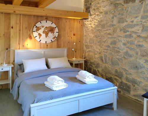 a bedroom with a bed with towels on it at El Chalet de Navacerrada in Navacerrada