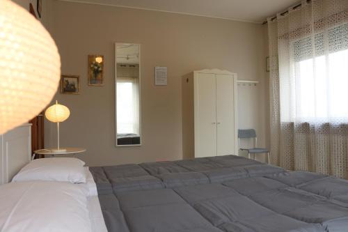 a bedroom with a large bed and a window at EasyRoom Schio in Schio