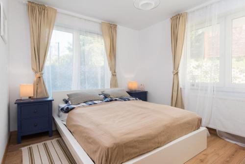 Postel nebo postele na pokoji v ubytování Apartamenty - Blue Side Family