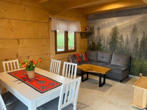 a living room with a table and a couch at Osada pod Giewontem 3 - KACPROWY in Czerwienne