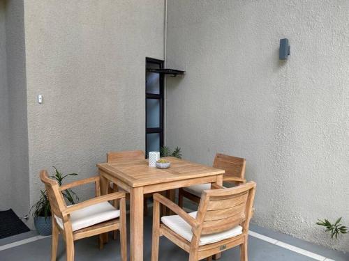 a wooden table and two chairs and a table and chairsktop at Superbe appartement en bord de plage in Bain Boeuf