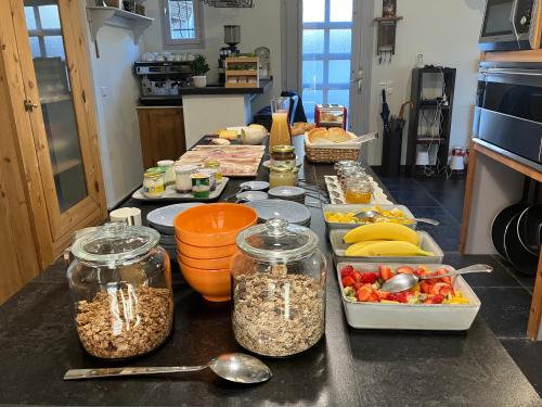 a kitchen counter with jars of food and fruits and vegetables at LE LIT QUI DANSE in Mollans-sur-Ouvèze