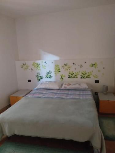 a bedroom with a large bed and two night stands at Marghe Town in Lazise