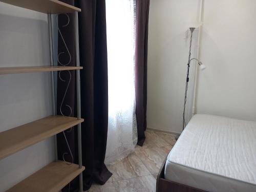 a bedroom with a bed and a window at Sunny Ventspils 21 in Ventspils