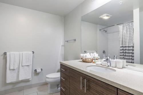 a bathroom with a sink and a toilet and a mirror at Lower Nob Hill 2BR w Roofdeck BBQ WD nr SFMH SFO-283 in San Francisco
