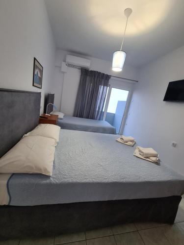 a bedroom with a large bed with a window at Lyttos in Tsoútsouros