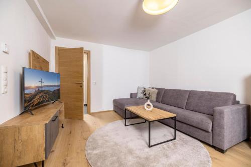 a living room with a couch and a table at Apartments Austria in Söll