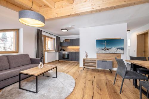 a living room with a couch and a table at Apartments Austria in Söll
