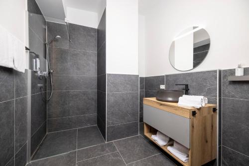 a bathroom with a shower and a sink at Apartments Austria in Söll