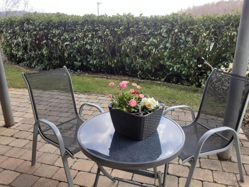 un tavolo con un cesto di fiori sopra di Ferienwohnung Josi a Heidenheim an der Brenz