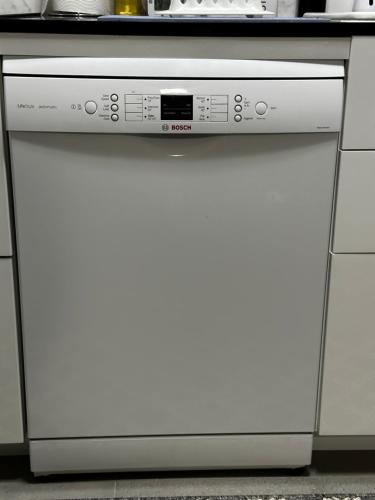 a white dishwasher in a kitchen with a counter at Luxury Boutique Self-Contained Private Granny Flat in Ormeau
