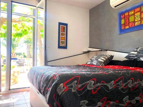 - une chambre dotée d'un lit avec une couverture noire et rouge dans l'établissement Villa Playa, à L'Ametlla de Mar