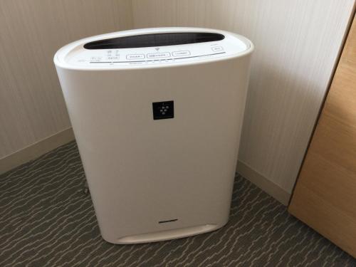 a white trash can sitting next to a wall at Naha Tokyu REI Hotel in Naha