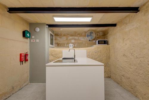 a kitchen with a white counter in a room at Casa Domenico 6 in Valletta