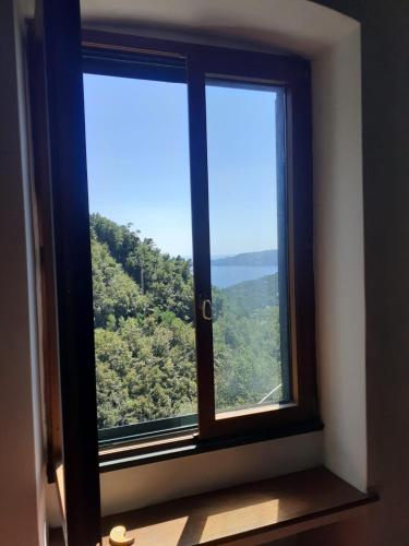 a window with a view of a mountain at Casa Madeleine in Zoagli