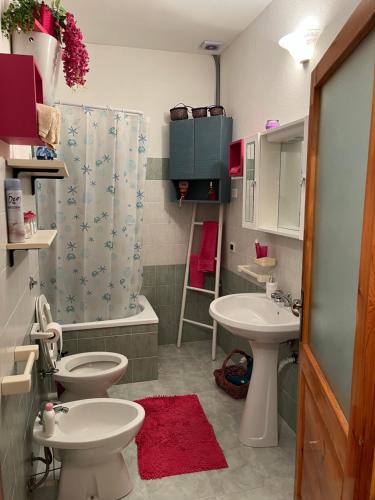 a bathroom with two toilets and a sink and a shower at B&B Roseddu in Bitti