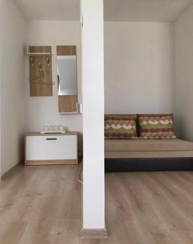 a room with a bed and a sink at Vila Norina in Oeşti-Pămînteni
