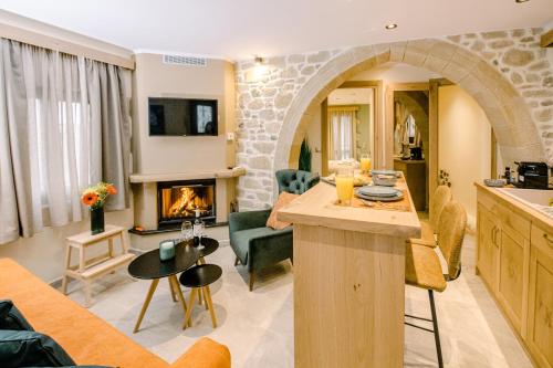 a living room with a kitchen and a living room with a fireplace at Alonion Apartments in Yerakianá