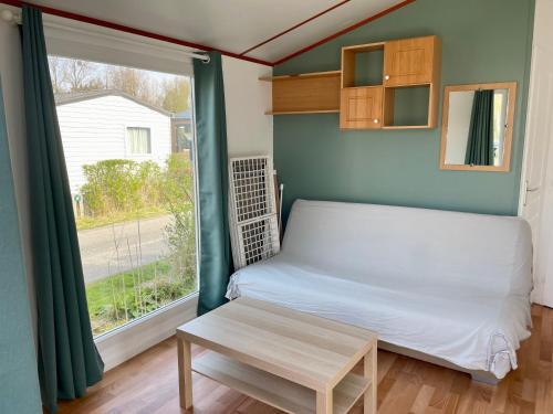 une petite chambre avec un lit et une fenêtre dans l'établissement Camping Les Tourterelles, à Rang-du-Fliers