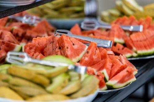 a bunch of fruit on plates on a table at Prestige Deluxe Hotel Aquapark Club - All inclusive in Golden Sands