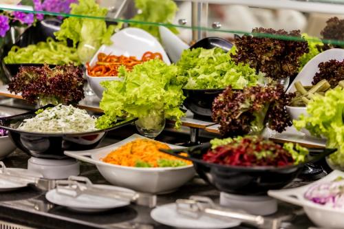 a buffet filled with bowls of different types of vegetables at Prestige Deluxe Hotel Aquapark Club - All inclusive in Golden Sands