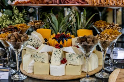 a platter of cheese and other desserts in wine glasses at Prestige Deluxe Hotel Aquapark Club - All inclusive in Golden Sands
