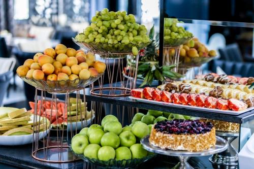 a display of different types of fruits and desserts at Prestige Deluxe Hotel Aquapark Club - All inclusive in Golden Sands