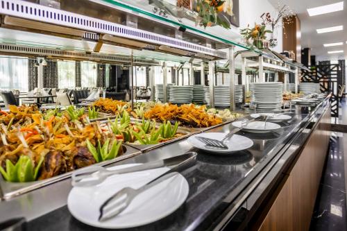 a buffet line with plates of food at Prestige Deluxe Hotel Aquapark Club - All inclusive in Golden Sands
