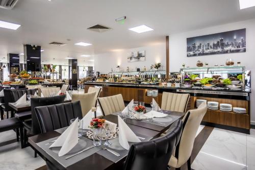 a restaurant with tables and chairs and a bar at Prestige Deluxe Hotel Aquapark Club - All inclusive in Golden Sands