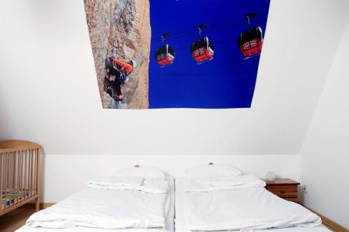 a bedroom with two beds and a blue wall at Podlesice 38 in Kroczyce