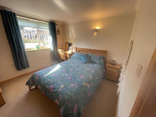 a bedroom with a bed and a window at Sunnyside in Veryan