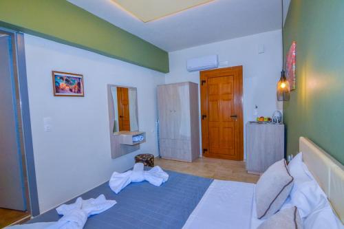 a bedroom with a large bed with a blue blanket at Elafonisi Paradise with Parking, WiFi, - Walking Distance to the Beach in Elafonisi