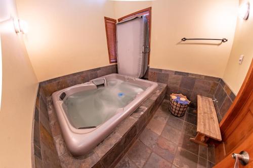 a bathroom with a large tub in a room at Snowy Creek 04 - Ski In Ski Out, Private Hot Tub, Short Walk to Whistler Village in Whistler